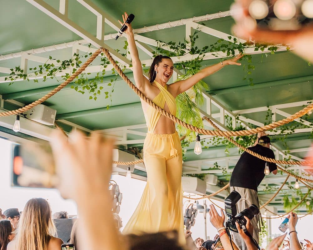 girl on top of dj booth