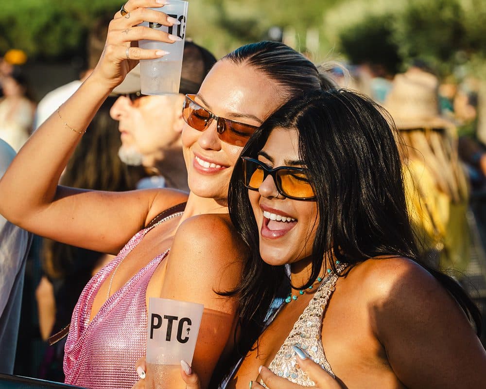 two girls posing with drinks